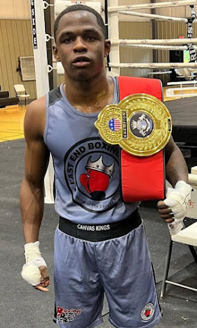 East End Boxing Club fighter holding a championship belt