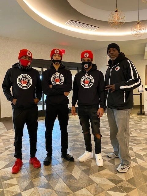 Coaching staff in club gear in the lobby