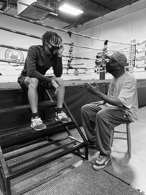 Coach Pat mentoring a fighter at East End Boxing Club