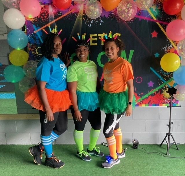 Members dressed up for a glow workout party